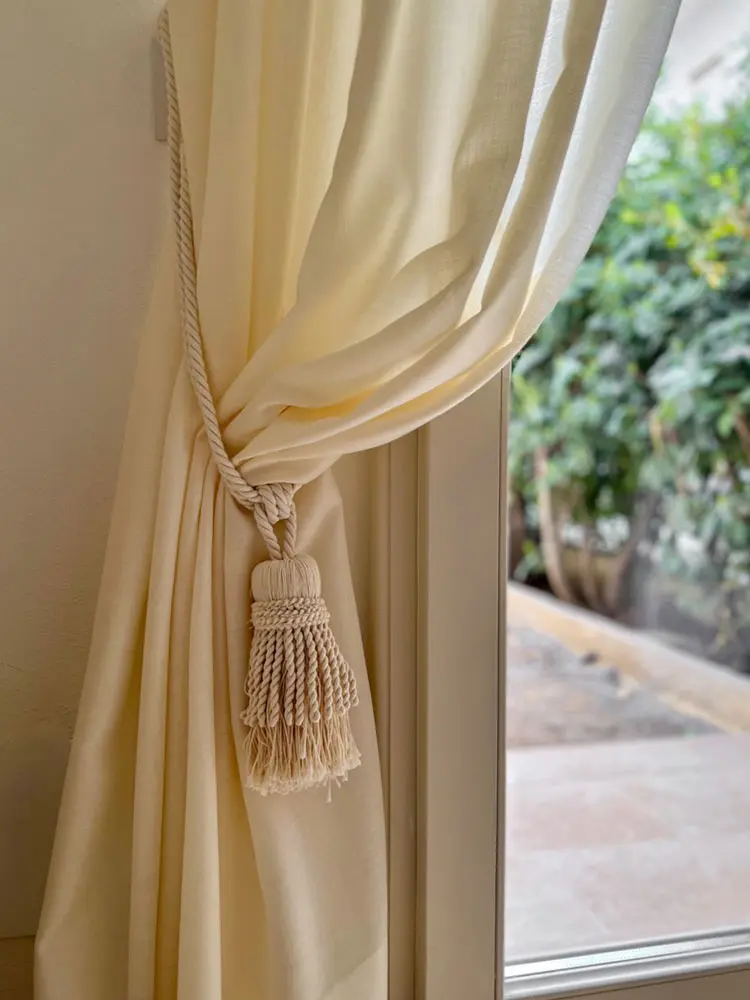 Cord and tassel trimmings to decorate the interior curtains of a flat in Marina a Pietrasanta