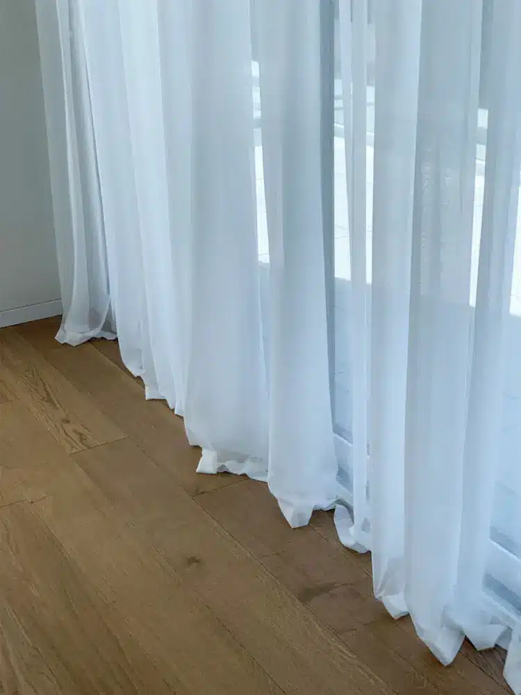 Modern, minimalist white interior blinds to filter natural light