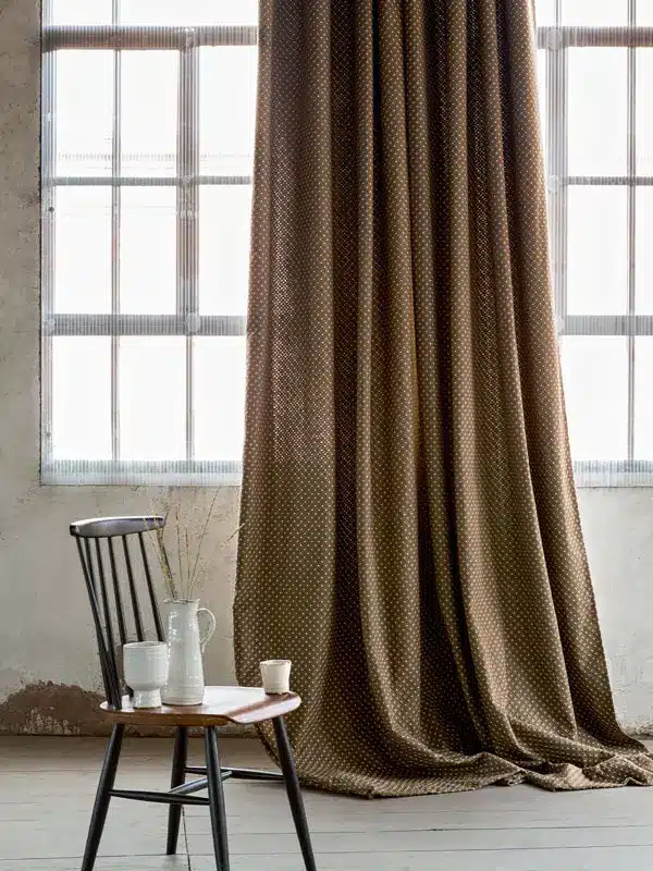A decorative curtain made of fabric from the Effigie collection by Elitis for which Zefiro Interiors is an official dealer
